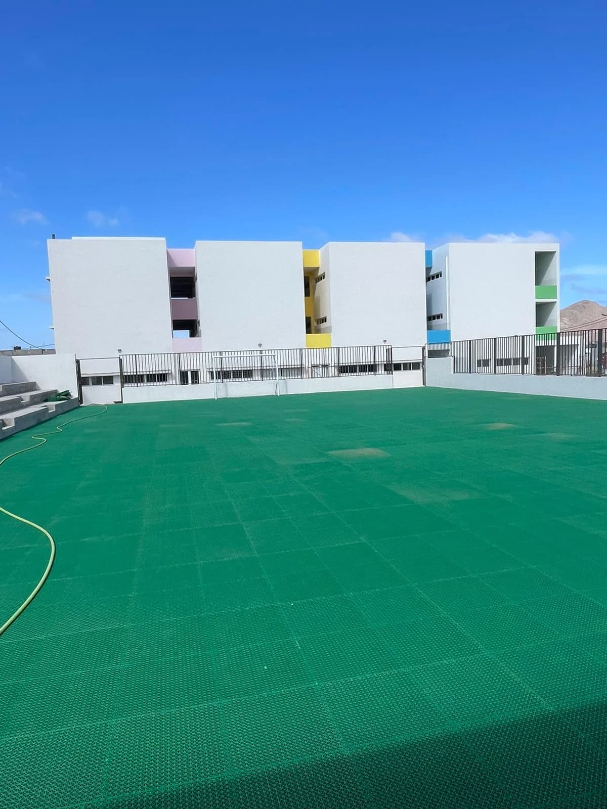 Edifício concluído junto a um campo desportivo de superfície verde